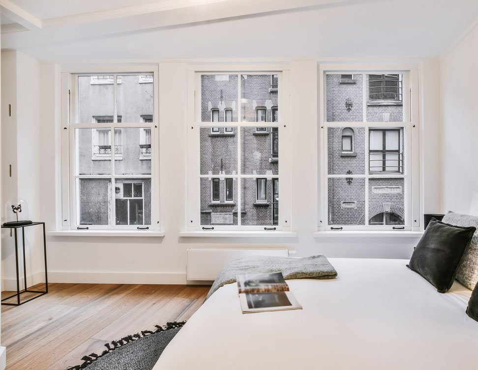 Photo of large vintage style double pane windows installed in a loft